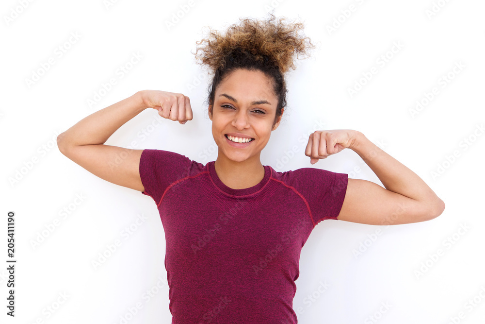 young woman smiling and flexing arm muscle young woman smiling and flexing arm muscle