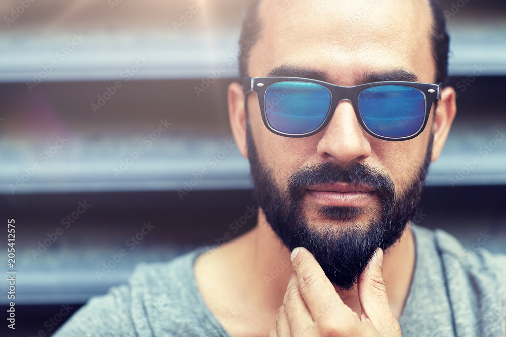 lifestyle, emotion, expression and people concept - man in sunglasses touching beard on city street lifestyle, emotion, expression and people concept - man in sunglasses touching beard on city street