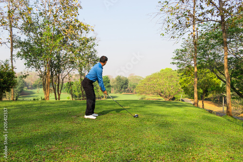 Man playing golf on a golf course.