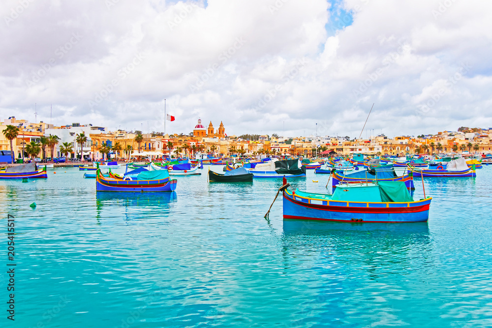 Luzzu boats at Marsaxlokk harbor in bay Mediterranean sea Malta