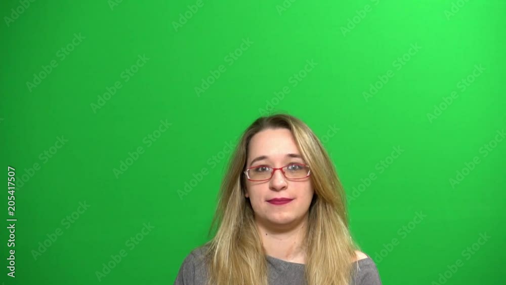 Young girl posing. She waves her hand. Then disappears down. Background green screen. Young girl posing. She waves her hand. Then disappears down. Background green screen.