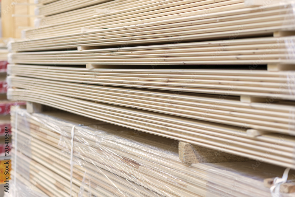 Packed boards in the building store. dry flat boards stacked together. close-up. building materials Packed boards in the building store. dry flat boards stacked together. close-up. building materials