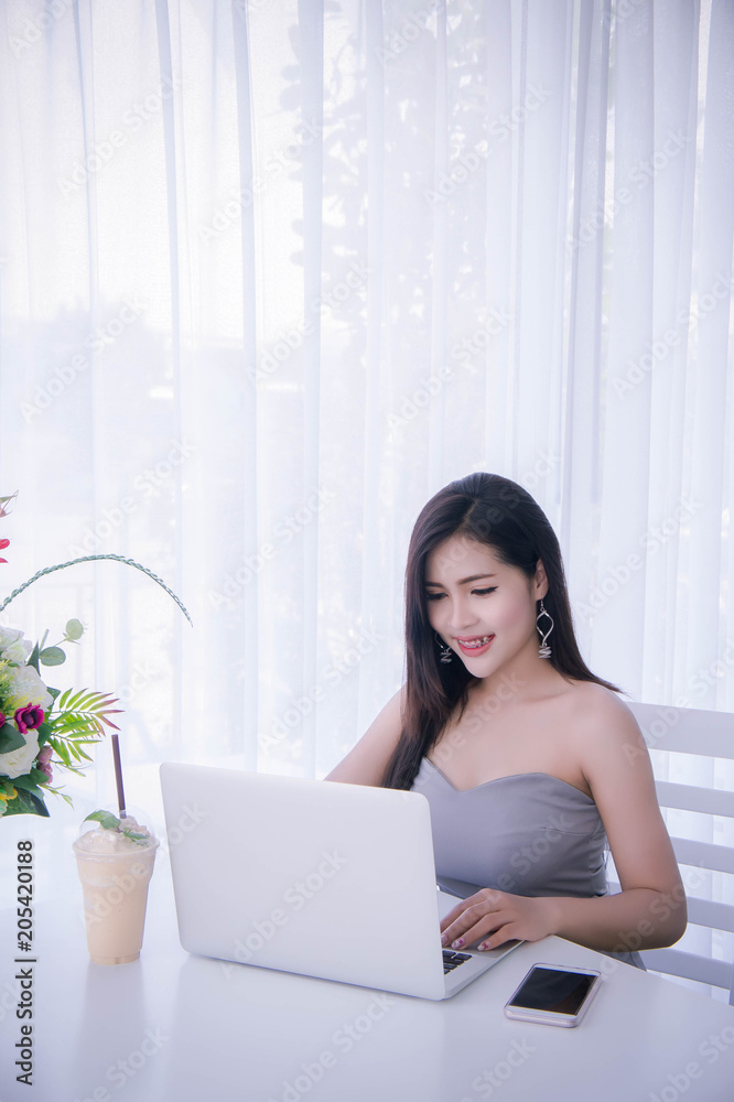 Smart girl's working on notebook , Workingwoman using laptop in the room Smart girl's working on notebook , Workingwoman using laptop in the room