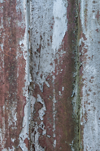 Rusty metal background with old layers of silver paint. Texture rusted shipping container