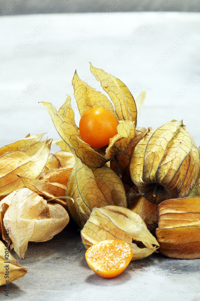 Fresh physalis on grey background. raw sweet small fruit Fresh physalis on grey background. raw sweet small fruit