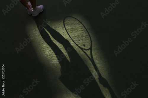 Tennis competition concept shadow of Woman holding racket playing tennis