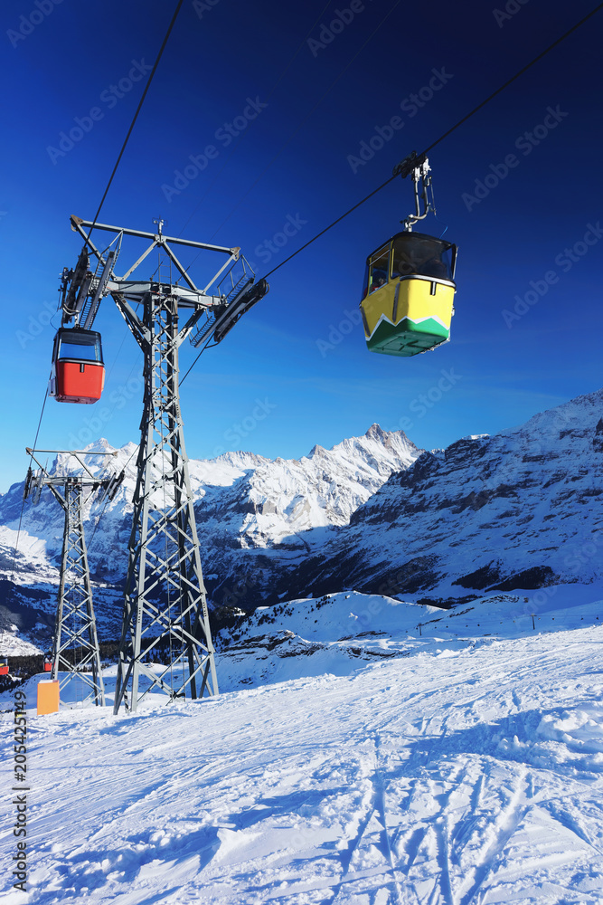 Cable car cabins in winter sport resort Swiss Alps Mannlichen Cable car cabins in winter sport resort Swiss Alps Mannlichen