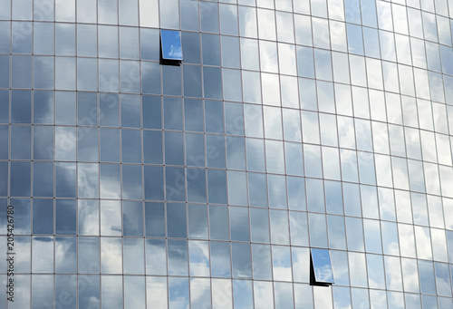 Reflection of clouds in the facade of the building