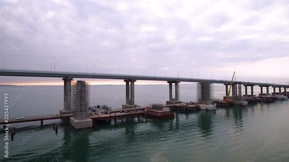 KERCH, RUSSIA, May 16, 2018: Aerial view of The Crimean Bridge, Kerch Bridge, colloquially the Kerch Strait Bridge with road and rail passages across the Kerch Strait, which will connect the Taman KERCH, RUSSIA, May 16, 2018: Aerial view of The Crimean Bridge, Kerch Bridge, colloquially the Kerch Strait Bridge with road and rail passages across the Kerch Strait, which will connect the Taman