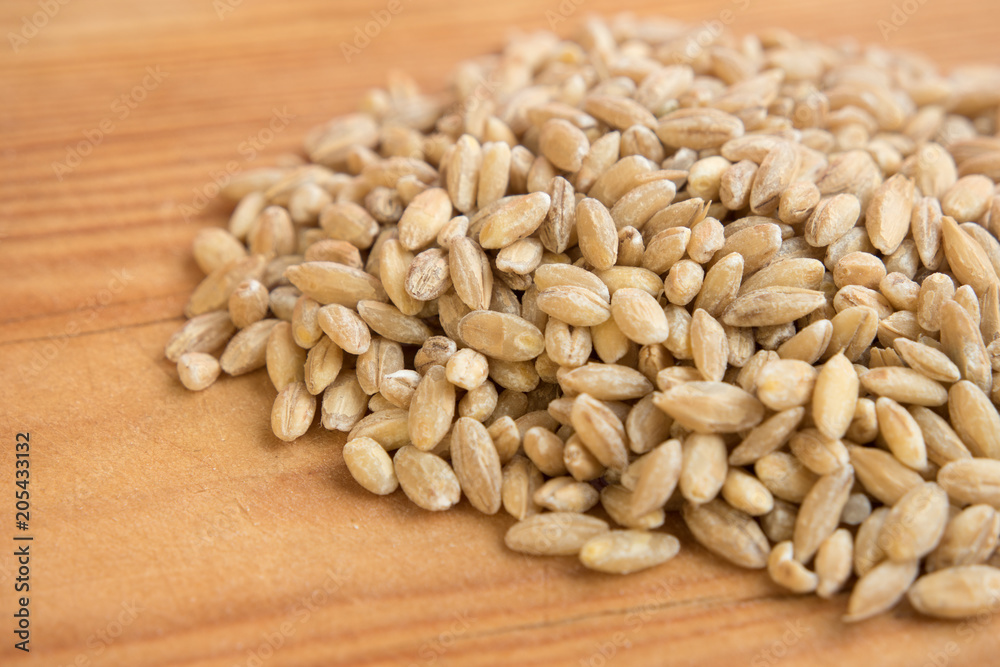 stack of barley pearl in wooden background. stack of barley pearl in wooden background.