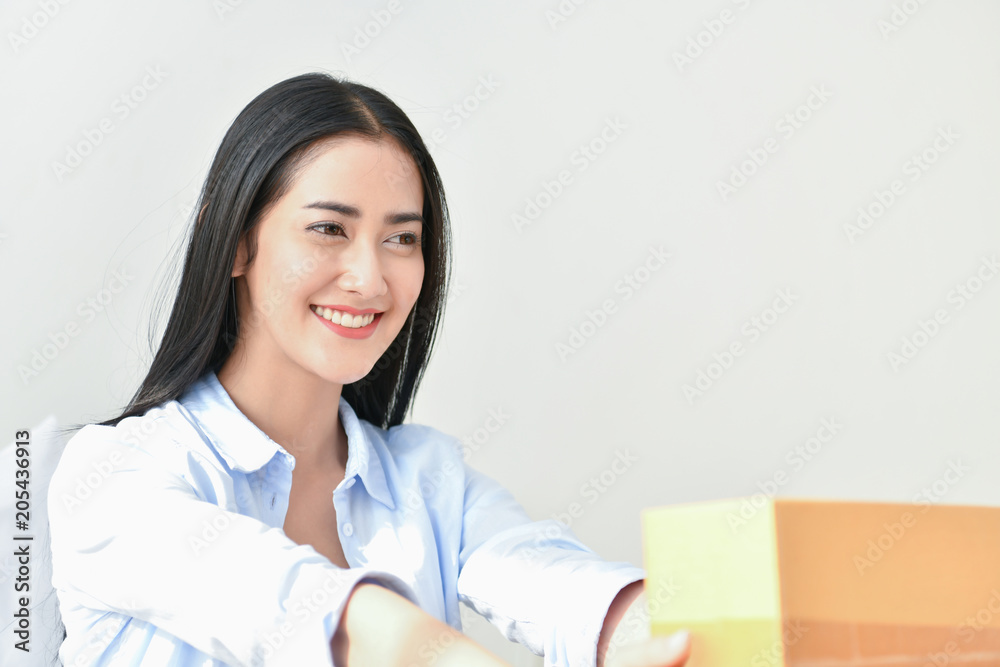 Sme business concept. Young people are packing their packages.Delivery business Small and Medium Enterprise (SMEs). Young woman is working in the house.Young Owner Start up for Business Online. Sme business concept. Young people are packing their packages.Delivery business Small and Medium Enterprise (SMEs). Young woman is working in the house.Young Owner Start up for Business Online.