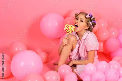 Party balloons, kid in curlers, pajama fashion.