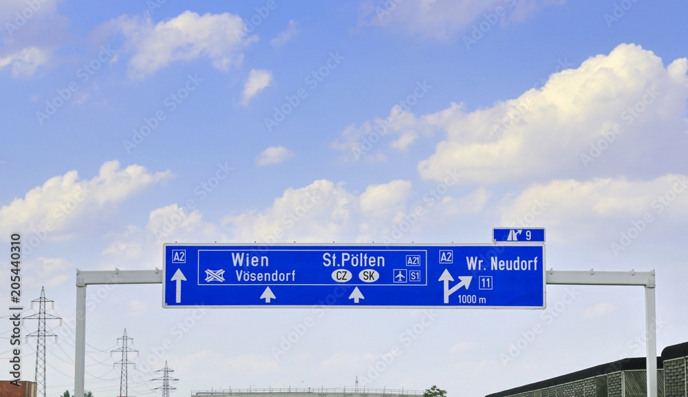 road signs which indicate the road to Vienna