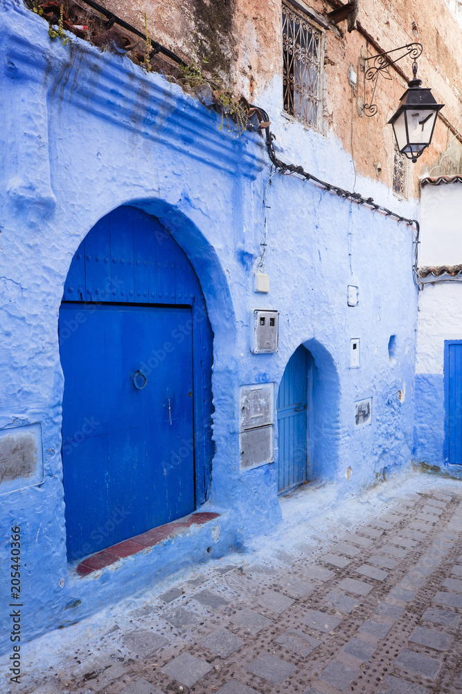 blue door and walls on the street in Moroccan city