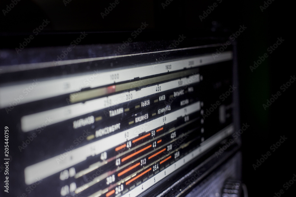Radio scale on black background, old radio close up, front and back background blurred Radio scale on black background, old radio close up, front and back background blurred