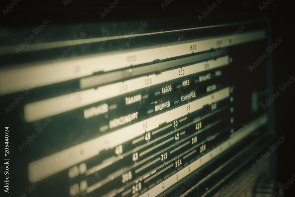 Radio scale on black background, old radio close up, front and back background blurred Radio scale on black background, old radio close up, front and back background blurred