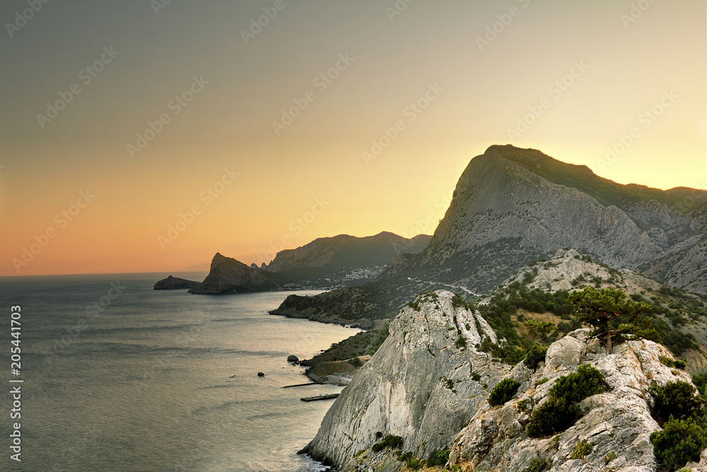 View of the mountains and the coast of Crimea in Sudak at sunset
