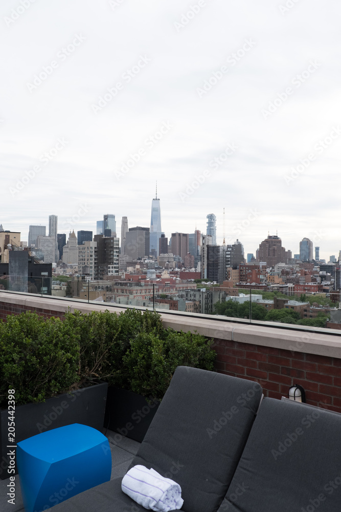  View of Freedom Tower and lower Manhattan from the posh rooftop bar Mr Purple and swimming pool atop Hotel Indigo on Orchard Street in New York City.