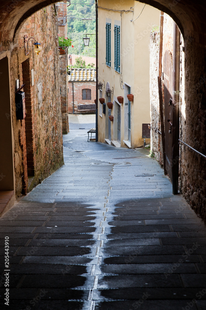 medieval narrow sreet in asciano, Italy