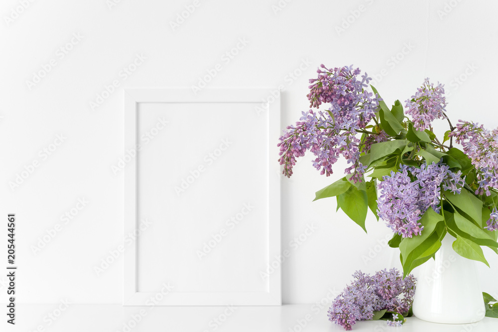 White frame with lilac bouquet on white background White frame with lilac bouquet on white background