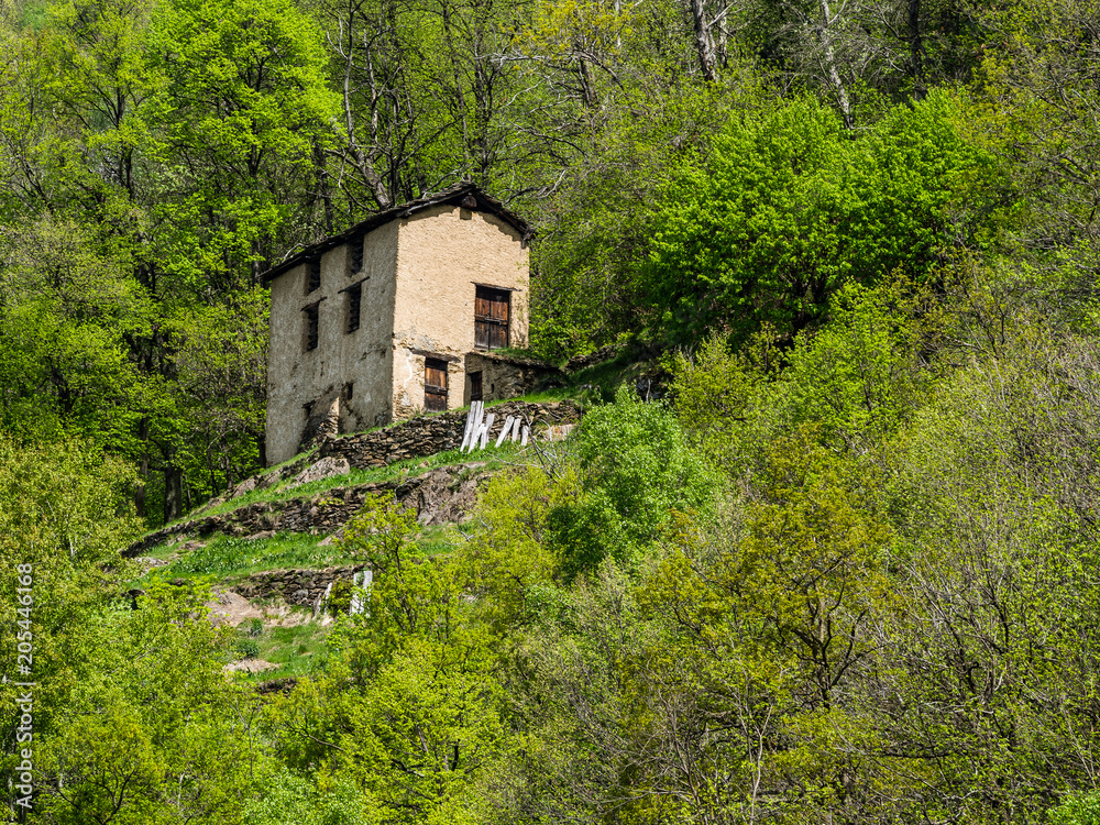 Old abandoned house in the mountain village Noceno in Lombardy in Italian Alps