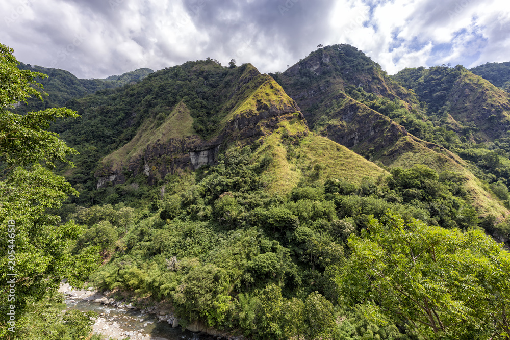 A canyon with a small river at the bottom near the small village of Ndungga, Flores, Indonesia.