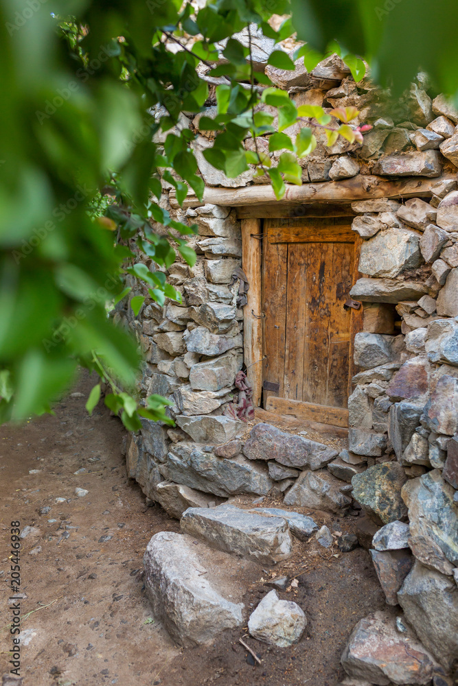 Old wooden door in stone house in Dah village, Ladakh region, India Old wooden door in stone house in Dah village, Ladakh region, India