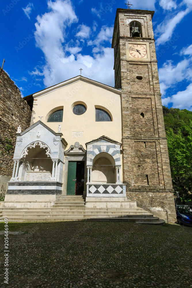DERVIO, ITALY - APRIL 30th 2018: old Parrocchia Prepositurale Ss.Pietro E Paolo church standing in the center of the Italian village Dervio by the Como lake, lit by the spring sun.