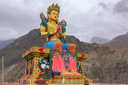 Maitreya Buddha statue with Himalaya mountains in the back at Diskit Monastery, Nubra Valley, Ladakh, India.
