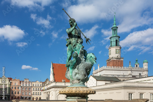 Neptune fountain with the city hall tower in the background on the Main Market (Rynek) square in the Old Town of Poznan, Poland