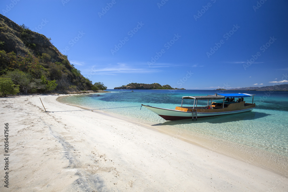 A boat on an empty beach in the Seventeen Island National Park near Riung, Indonesia.