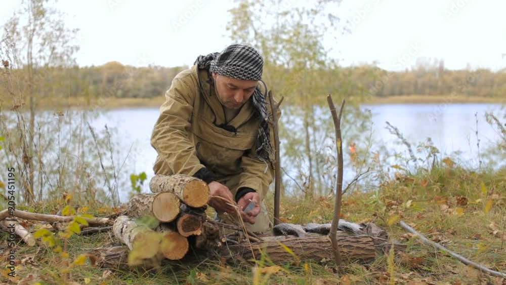 tourism, a man kindles a fire in a hike tourism, a man kindles a fire in a hike