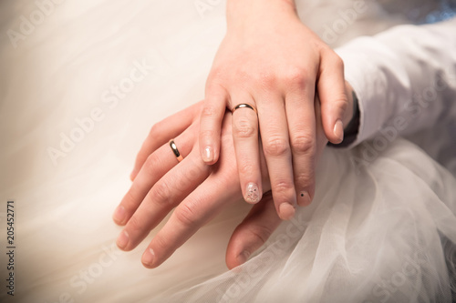 Hands of just married bride and groom with rings. Wedding photograph