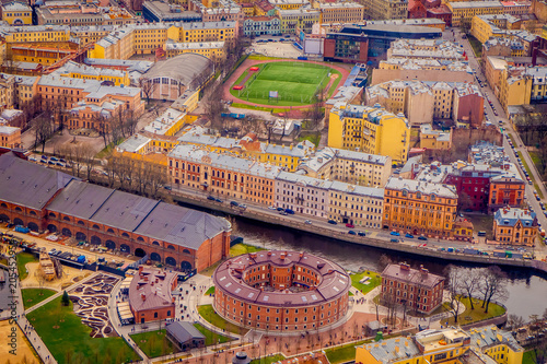 Beautiful above view of roofs of buildings at historical center close to Moyka River in Saint Petersburg, summer day, lot of old buildings and industrial zone at the horizon