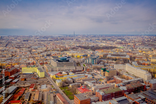 Above view of buildings at historical center of Saint Petersburg in summer day, buildings and industrial zone at the horizon with a city landscape photo