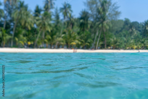 Green water in the sea background with selective focus. Beach on Koh kood Island in Thailand.