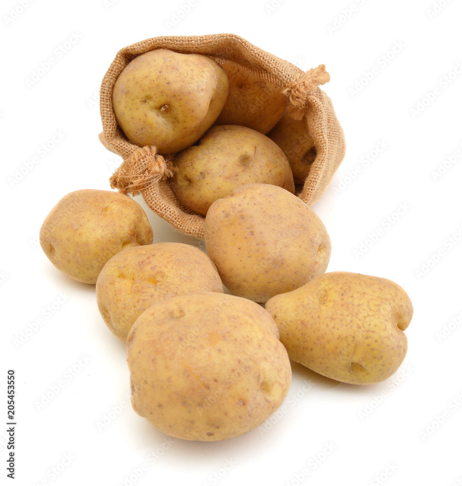Raw potatoes in burlap sack isolated on white background Raw potatoes in burlap sack isolated on white background