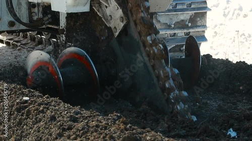 tractor digs a trench photo