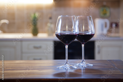 two glasses of red wine on kitchen table