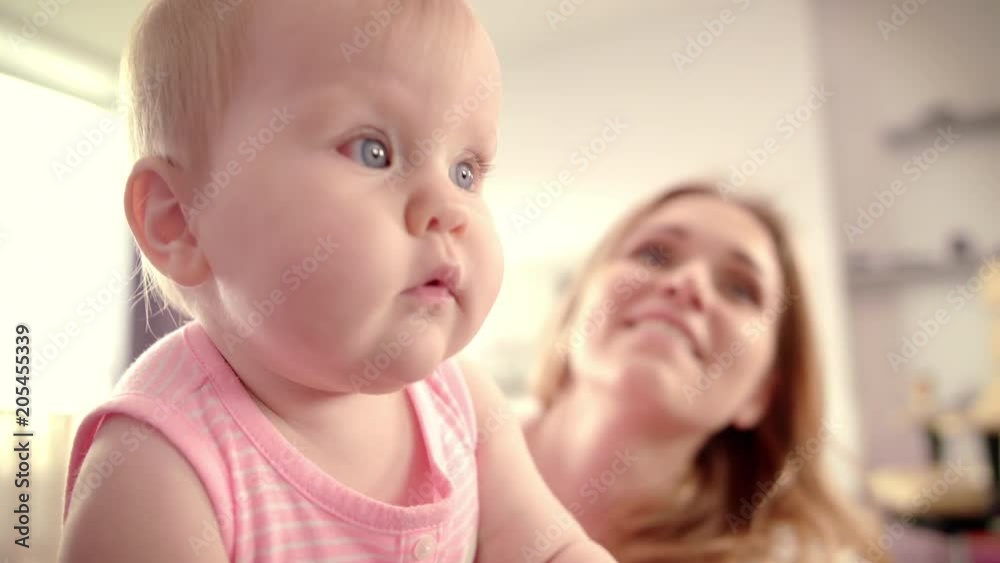 Cute baby girl with toy. Toddler gnawing green toy frog. Little child eating rubber toy. Sweet child playing at home. Infant baby looking around. Baby lifestyle. Happy loving family Cute baby girl with toy. Toddler gnawing green toy frog. Little child eating rubber toy. Sweet child playing at home. Infant baby looking around. Baby lifestyle. Happy loving family