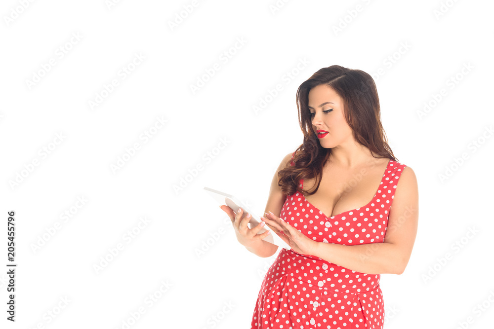 attractive plus size woman in red dotted dress using tablet isolated on white attractive plus size woman in red dotted dress using tablet isolated on white
