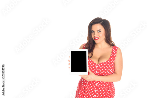 beautiful plus size woman in red dress holding tablet with blank screen isolated on white