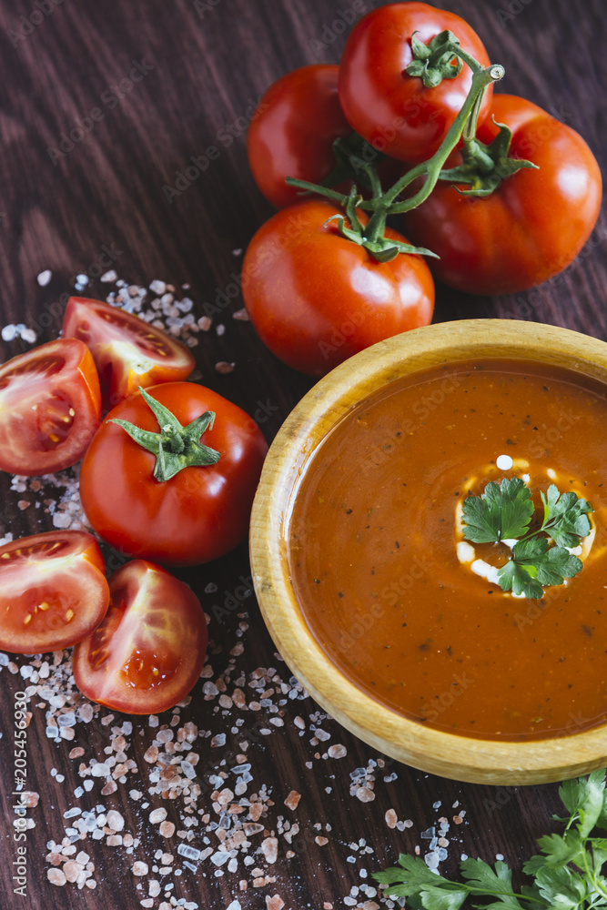 Tomato soup in a wooden bowl Tomato soup in a wooden bowl
