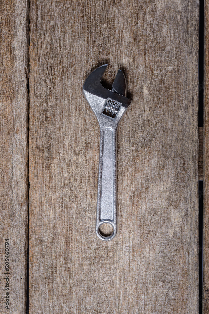 Adjustable Wrench tool on wooden background. Top view Adjustable Wrench tool on wooden background. Top view