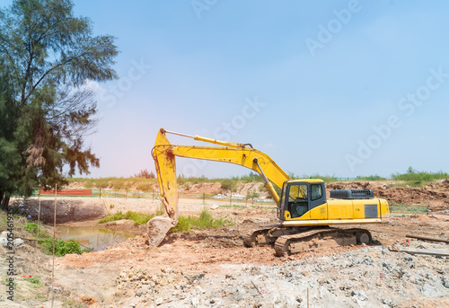 Heavy earth mover with blue sky in the background