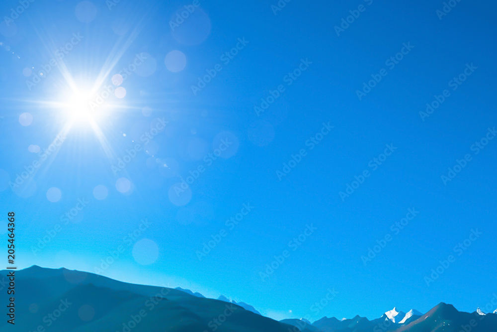 Blue sky with sunny sun and mountain.