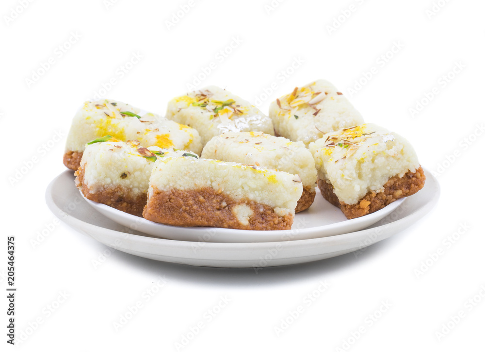 Indian Diwali Sweet Food Kalakand Also Know as Halwa or Mawa Kalakand is a Creamy Delicacy Made From Paneer or Cottage Cheese, The Dish Originated in Alwar, Rajasthan. Isolated on White Background Indian Diwali Sweet Food Kalakand Also Know as Halwa or Mawa Kalakand is a Creamy Delicacy Made From Paneer or Cottage Cheese, The Dish Originated in Alwar, Rajasthan. Isolated on White Background