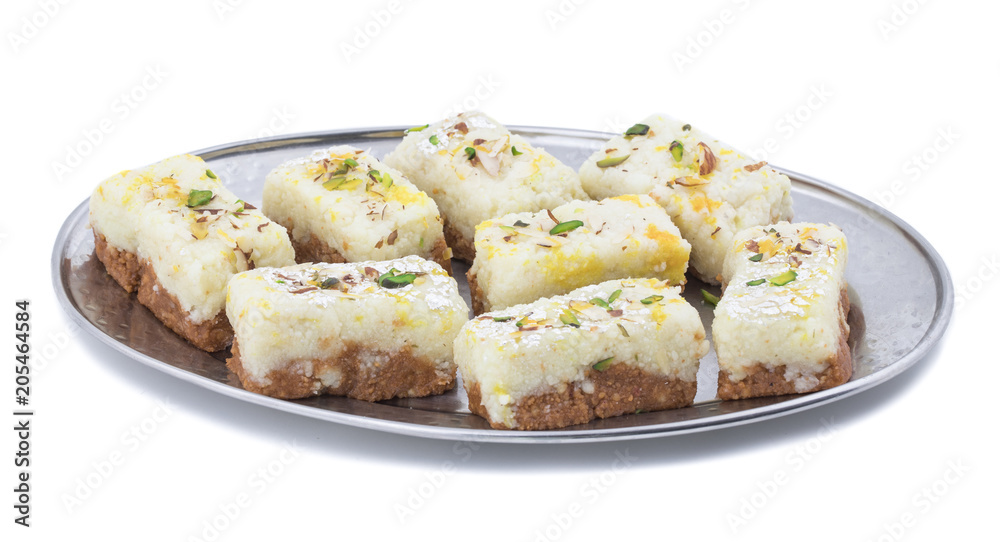 Indian Diwali Sweet Food Kalakand Also Know as Halwa or Mawa Kalakand is a Creamy Delicacy Made From Paneer or Cottage Cheese, The Dish Originated in Alwar, Rajasthan. Isolated on White Background Indian Diwali Sweet Food Kalakand Also Know as Halwa or Mawa Kalakand is a Creamy Delicacy Made From Paneer or Cottage Cheese, The Dish Originated in Alwar, Rajasthan. Isolated on White Background