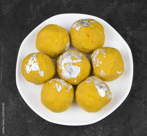 Besan Laddu Indian Traditional Sweet Food Also Know as Laddoos, laddoo, ladoo, laddo Are Ball-Shaped Sweets Popular in The Indian Festivals. Laddu on Black Textured Background