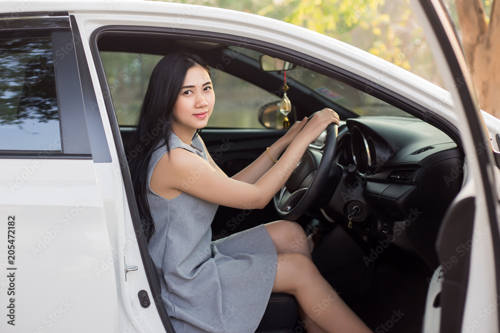 Cute young lady happy driving car